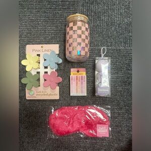 Assorted gifts - hair clips, Burt’s bees, sleep mask, tumbler and bath bombs